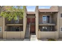 Multi-story tan building with red tile roof and wrought iron details on the second-floor balcony at 5525 E Thomas Rd # K16, Phoenix, AZ 85018