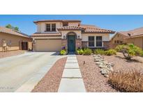 Charming two-story home with landscaped front yard, rock accents, and tiled roof at 597 S 221St Dr, Buckeye, AZ 85326