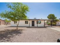 Charming single-story home featuring a gravel yard, covered entry, and convenient covered parking at 10693 N Arapaho Dr, Casa Grande, AZ 85122