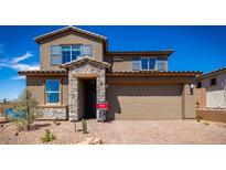 Beautiful two-story home with stone accents, a large two-car garage and manicured landscaping at 12233 W Caraveo Pl, Peoria, AZ 85383