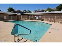 Outdoor community pool with pristine, sparkling water and handicap accessible railings at 1622 E Campbell Ave # L, Phoenix, AZ 85016