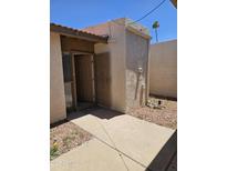 Inviting front entrance featuring a secure metal gate and covered entry way at 189 Laguna E Dr, Litchfield Park, AZ 85340