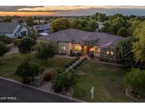 Beautiful single-story home with a stone facade, tile roof, and lush landscaping at 21228 E Excelsior Ave, Queen Creek, AZ 85142