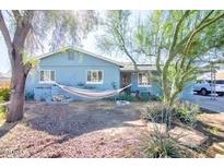 Charming single-story home featuring a front yard with mature trees and a relaxing hammock at 2335 W Campus Dr, Phoenix, AZ 85015