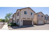 Charming two-story home featuring a neutral color palette, two car garage, and well maintained landscaping at 2668 N 73Rd Gln, Phoenix, AZ 85035