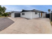 An exterior view of a modern home showcasing the garage and sleek design at 3002 W Mandalay Ln, Phoenix, AZ 85053