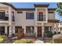 Charming townhouse featuring stucco exterior, private gated patio, and an inviting front entrance at 3150 E Beardsley Rd # 1091, Phoenix, AZ 85050