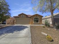 Charming single-story home featuring a neutral-toned exterior and a well-manicured desert landscape at 40168 W Sanders Way, Maricopa, AZ 85138