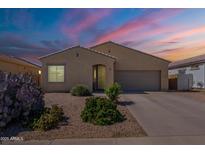 Charming single-story home featuring desert landscaping and an attached two-car garage at 42406 W Posada Dr, Maricopa, AZ 85138