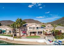 Stunning backyard with lush landscaping, patio, and private boat dock access to the canal at 5281 W Quail Ave, Glendale, AZ 85308