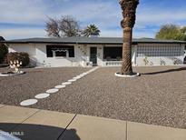 Charming single-story home with well-manicured gravel yard and unique privacy screen details at 5728 E Dodge St, Mesa, AZ 85205