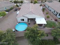 Aerial view of backyard featuring a pool, gravel landscaping, and covered patio at 5735 S Cloverdale Ln, Gilbert, AZ 85298