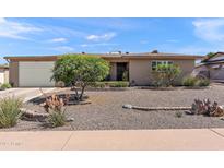 Charming single-story home with desert landscaping, an attached garage, and a tidy facade at 6448 E Des Moines St, Mesa, AZ 85205