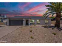 Charming single-story home featuring a two-car garage and desert-style landscaping for easy maintenance at 6944 E Gary Cir, Mesa, AZ 85207