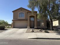 Inviting two-story home with a two-car garage and well-maintained front yard landscaping at 12547 W Pasadena Ave, Litchfield Park, AZ 85340