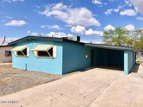 Charming single-story home with a blue exterior, a covered carport, and desert landscaping at 2258 E Alpine Ave, Mesa, AZ 85204