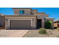 Charming two-story home features a paver driveway, tan stucco, and a two-car garage at 2321 W Brookhart Way, Phoenix, AZ 85085