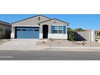 Charming single-story home featuring a blue garage door and decorative blue shutters at 37153 W Prado St, Maricopa, AZ 85138