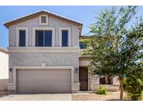 Two-story home featuring a beige stucco facade, neutral trim, and a two-car garage at 379 E Cheyenne Rd, San Tan Valley, AZ 85143
