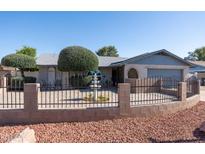 Charming single-story home featuring a private, enclosed front yard with a fountain at 3833 W Phelps Rd, Phoenix, AZ 85053