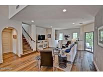 Inviting living room boasts hardwood floors, neutral walls, and a staircase leading to the upper level at 3935 E Rough Rider Rd # 1360, Phoenix, AZ 85050