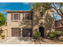Charming two-story home featuring a tile roof, dark brown shutters, and arched front door at 3964 E Hummingbird Ln, Phoenix, AZ 85050