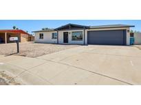 Charming single-story home featuring a spacious driveway, low-maintenance gravel landscaping, and a convenient attached garage at 4117 W Camino Acequia Ave, Phoenix, AZ 85051