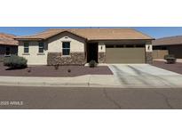 Charming single story home featuring stone accents, desert landscaping, and an attached two car garage at 6713 S 76Th Dr, Laveen, AZ 85339