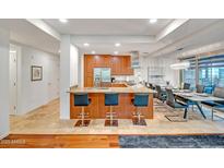 Open kitchen with granite counters, stainless steel appliances, and bar seating overlooking the dining area at 7157 E Rancho Vista Dr # 2012, Scottsdale, AZ 85251