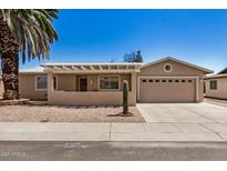 Charming single-story home featuring desert landscaping, a two-car garage, and a cozy front porch at 871 Leisure World --, Mesa, AZ 85206