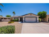 Charming single-story home features a well-manicured front yard and a two-car garage at 9339 E Sun Lakes N Blvd, Sun Lakes, AZ 85248