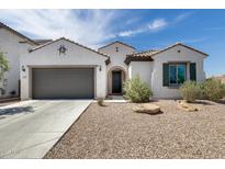 Charming single-story home featuring a low-maintenance front yard, two car garage and tile roof at 9723 W Patrick Ln, Peoria, AZ 85383