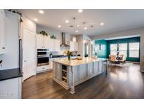 Modern kitchen featuring a large center island, stainless steel appliances, pendant lights and eat-in breakfast nook at 9723 W Patrick Ln, Peoria, AZ 85383