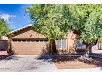 Charming single-Gathering home featuring a two-car garage and mature landscaping in a residential neighborhood at 2822 N 90Th Ave, Phoenix, AZ 85037
