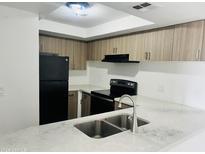 Well-lit kitchen featuring modern stainless steel appliances and white countertops at 4242 N 69Th Dr # 1303, Phoenix, AZ 85033