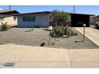 Charming single-story home with desert landscaping and covered parking at 513 S Cardinal Dr, Apache Junction, AZ 85120