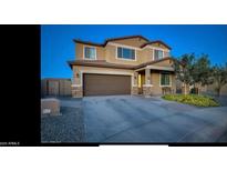 Charming two-story home featuring a two-car garage and well-maintained front yard at 5306 N 188Th Ln, Litchfield Park, AZ 85340