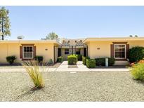 Charming single-story home with a well-maintained front yard and gated entry at 10468 W Palmeras Dr, Sun City, AZ 85373