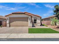 Charming single-story home with a well-manicured lawn and a tan color scheme at 1272 W Joshua Tree Ave, Queen Creek, AZ 85140