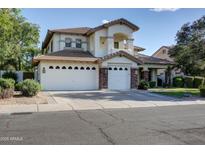 Spacious two-story home featuring a three-car garage and a well-manicured front yard at 1707 E Carob Dr, Chandler, AZ 85286