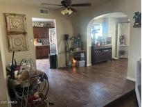 Open living room with tile flooring, ceiling fan, and views into the kitchen and dining areas at 1841 S Spruce --, Mesa, AZ 85210