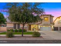 Charming two-story home featuring a manicured lawn and a two-car garage at 18518 E Ashridge Dr, Queen Creek, AZ 85142