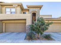 Modern home exterior featuring stone accents, tan siding, two-car garage and desert landscaping at 20121 N 76Th St # 2058, Scottsdale, AZ 85255