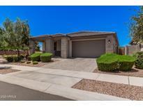Charming single-story home with well-manicured landscaping and a neutral color palette at 21824 S 226Th Pl, Queen Creek, AZ 85142