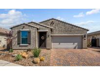 Charming single-story home with a two-car garage and low maintenance desert landscaping in front at 3048 W Thorn Tree Dr, Phoenix, AZ 85085