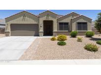 Charming single-story home featuring a well-manicured, low maintenance front yard and a two-car garage at 30776 W Earll Dr, Buckeye, AZ 85396