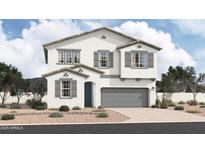 Charming two-story home showcasing a neutral color scheme, desert landscaping, and a two-car garage at 37581 W San Clemente St, Maricopa, AZ 85138