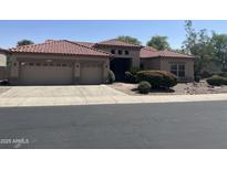Charming home with a two-car garage, desert landscaping and a red tile roof at 4581 E Apricot Ln, Gilbert, AZ 85298