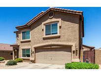 Two-story home showcasing a neutral stucco exterior, a tiled roof, and an attached two-car garage at 5110 E Mark Ln, Cave Creek, AZ 85331