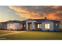 Charming single-story home featuring a well-manicured lawn and a beautiful sunset backdrop at 608 E Paint Your Wagon Trl, Phoenix, AZ 85085